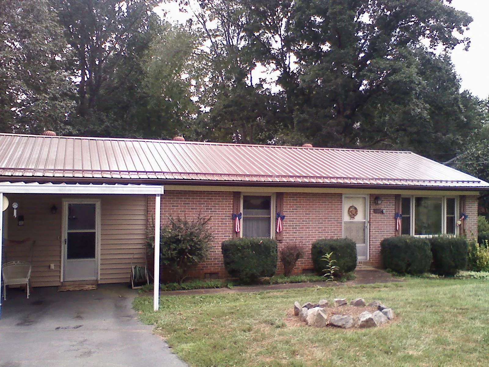 Bronze metal roof and carport on a brick ranch home — Roof Repair work by our crew in Langley